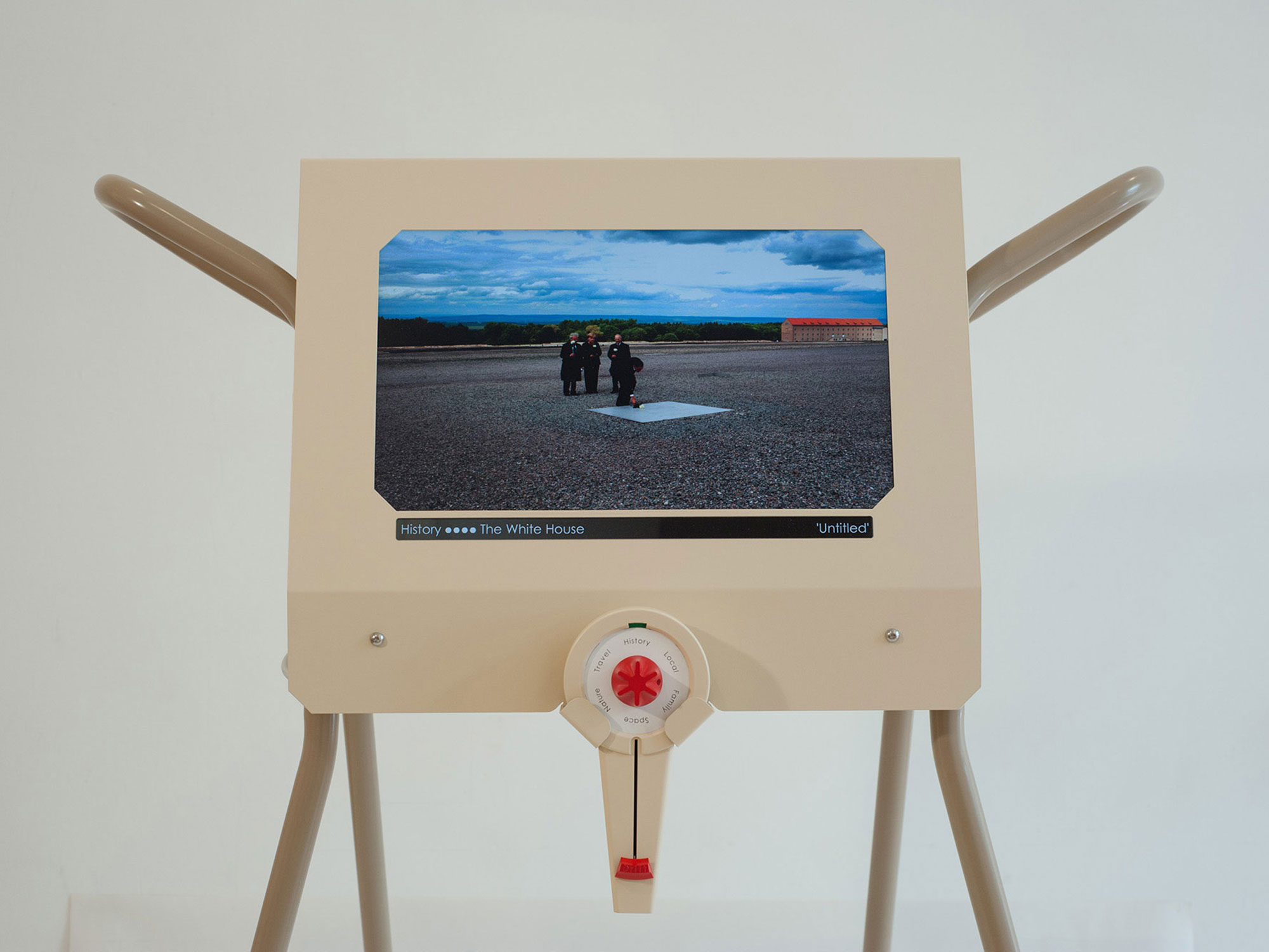 A photograph of the Photostroller featuring an image on the screen of Barack Obama attending a ceremony